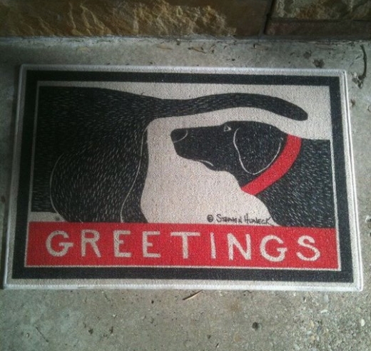 Greetings dog sniffing doormat